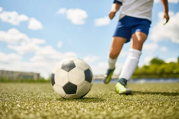 Foto op Plexiglas Boy Kicking Ball in Football © Seventyfour