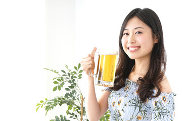 Young woman drinking beer outside