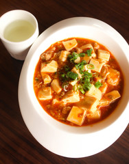 Chinese Food,Mapo doufu Chinese in white dish with tea cup