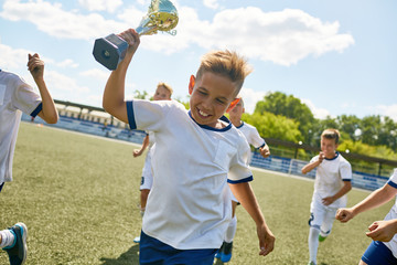 Boy Holding Trophy Cup