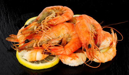 Group of whole fried king tiger prawns on a slate stone background