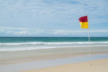 Red and yellow beach patrol flag on the Gold Coast.