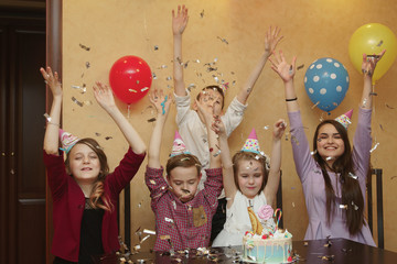 children throwing confetti at a children's party. happy birthday concept