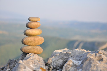 Balanced stone pyramid on mountain. Zen rock, concept of balance and harmony