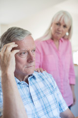 Mature Woman Comforting Man With Depression At Home