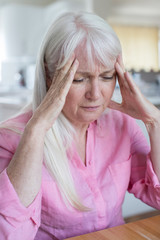 Mature Woman At Home Suffering From Headache