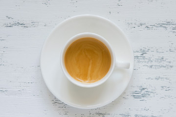 Cup of black coffee on the white table