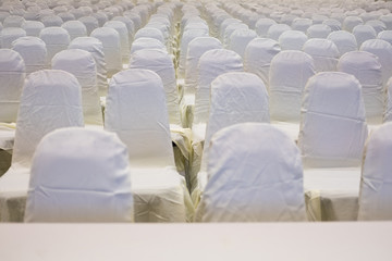 modern conference hall interior with white chairs. seminar room with empty seat. business event