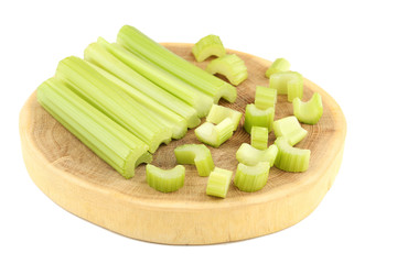 Celery on cutting board isolated on white