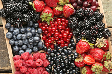 Ripe and sweet berries in wooden box