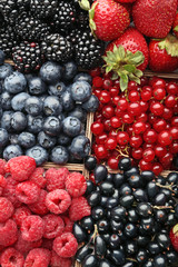 Ripe and sweet berries in wooden box