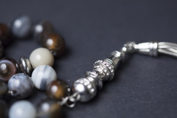 Part of rosary beads on a dark background