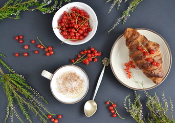 Cup of cappuccino, croissants, redcurrant
