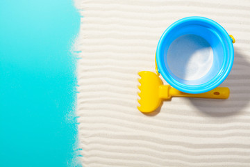 Bucket with rake on sand