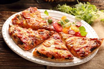 Homemade pizza on a white plate