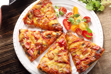 Homemade pizza on a white plate