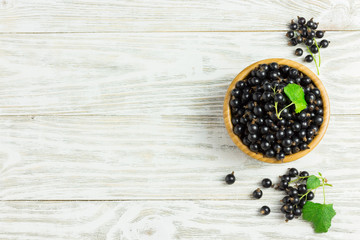 Delicious black berries in a bowl on white background. Cooking background. Top view copy space.
