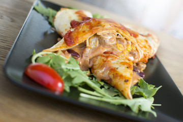 Pancakes with fried meat and vegetables. Pepper, cabbage, parsley in the filling.