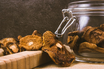 Dried forest mushrooms on a wooden table.