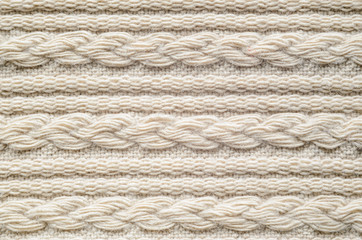 Pigtails on Beige Knitwear Fabric Texture. Machine Knitting Texture Macro Snapshot. Beige Knitted Background.