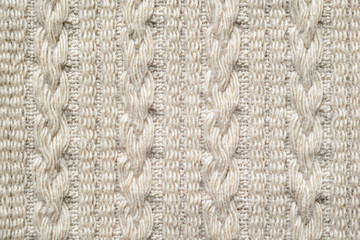Pigtails on Beige Knitwear Fabric Texture. Machine Knitting Texture Macro Snapshot. Beige Knitted Background.