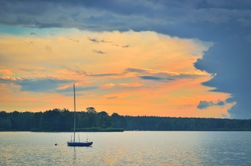 Boat on a beautiful lake. Evening summer landscape by the water.