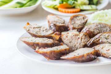 Northern Thai spicy sausage on white dish and table for lunch or dinner.