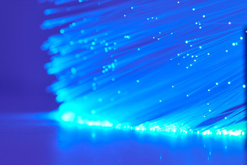 Background With Blue Fiber Optics And Reflections On The Table