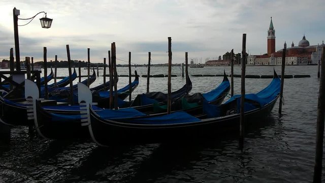 Gondolas on Venice Grand Channel floating on wawing water of lagoon with sound of sea view
