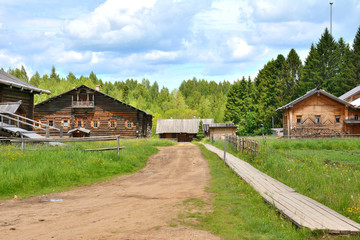 Village street with a dirt road and wooden sidewalks