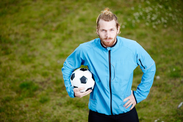 Confident soccer coach in sportswear