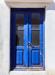 Fototapeta na wymiar Old wooden door in a Greek village