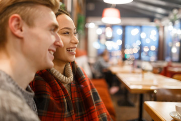 Bonding couple spending time in cafe after walk
