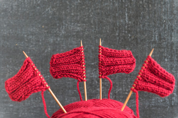 Sailing ships made from red yarn and knitting needles