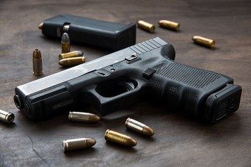 Gun with ammunition on dark background. 