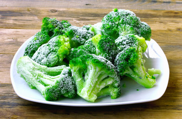 Fresh frozen broccoli on white plate