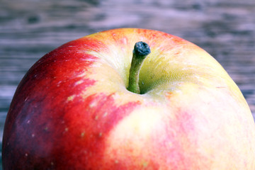 Ripe red apples on wooden background summer concept