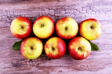 Ripe red apples on wooden background summer concept