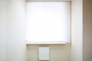 Window with white jalousie in modern apartment
