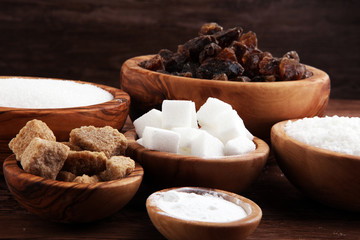 Sugar composition with white and brown sugar on wooden board