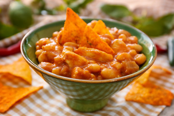 Bowl with delicious turkey chili on table