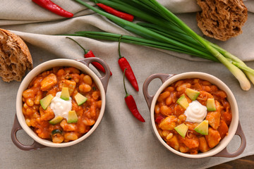 Two casserole dishes with delicious chili turkey on napkin