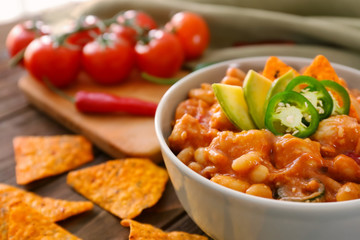 Bowl with delicious turkey chili on table
