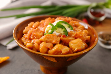 Bowl with delicious turkey chili on table