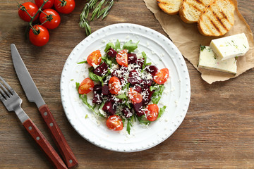 Plate with useful beet salad on wooden background