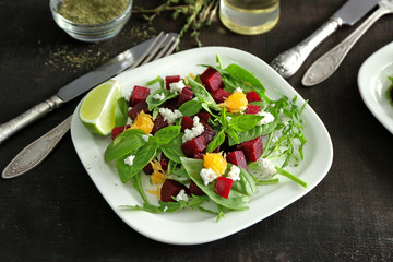 Plate with useful beet salad on table