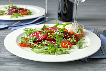 Plate with useful beet salad on table