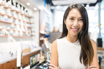 Young Woman holding small business in optician store