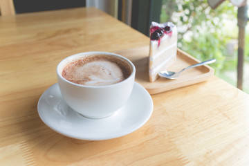 hot coffee mocha with foam milk and blueberry cake in countryside cafe