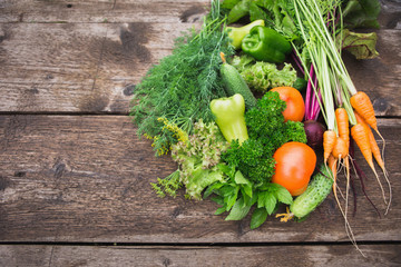 Background of fresh vegetables close-up. Cucumbers, fries, dill, parsley, beets, carrots, mint. Season harvesting.